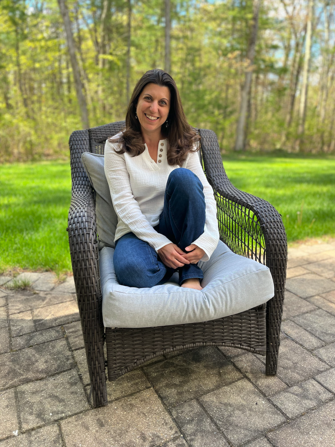 Therapy Keeper Team Member Stephanie sitting in a chair outside smiling at the camera