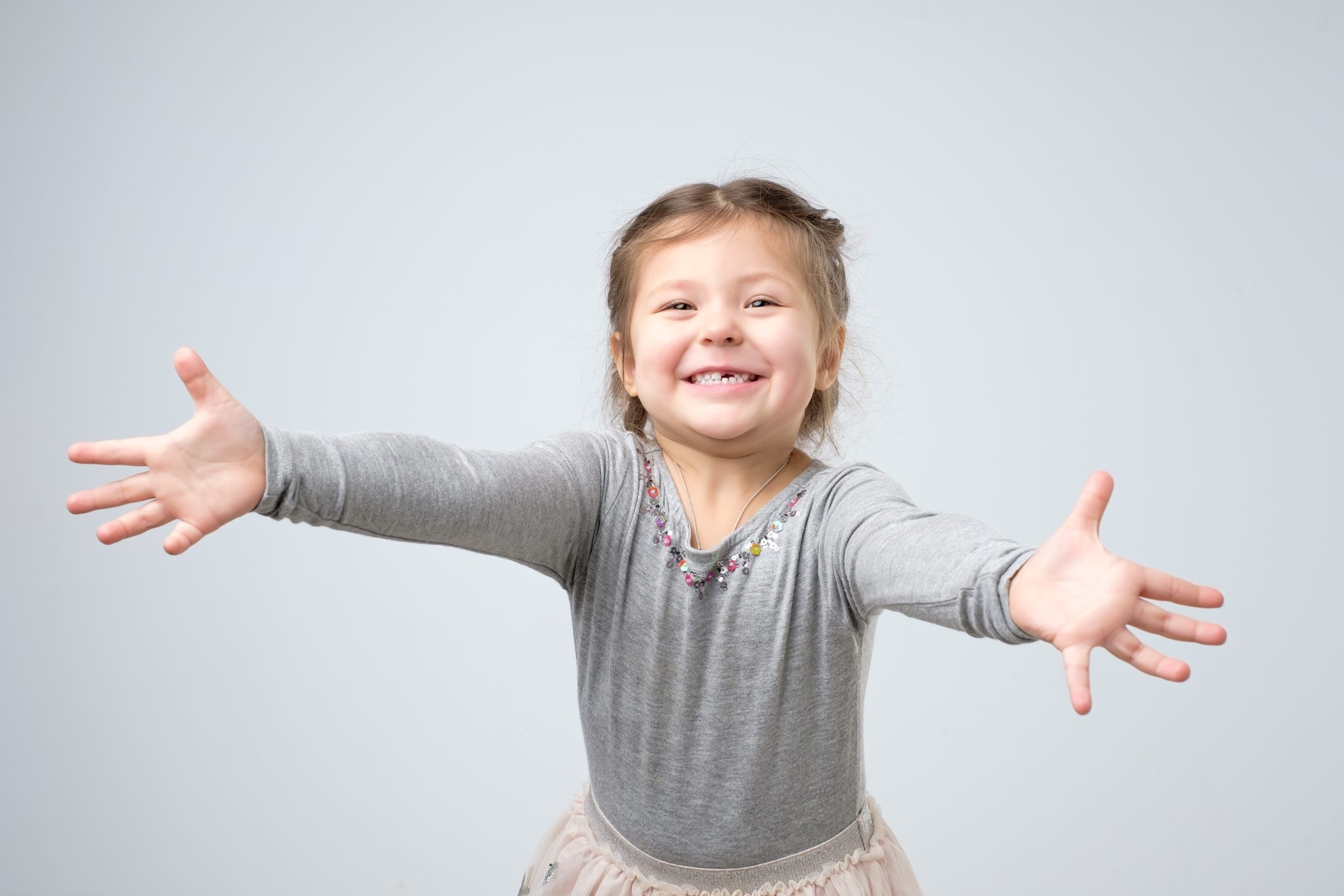 Girl reaching toward the camera to give a hug